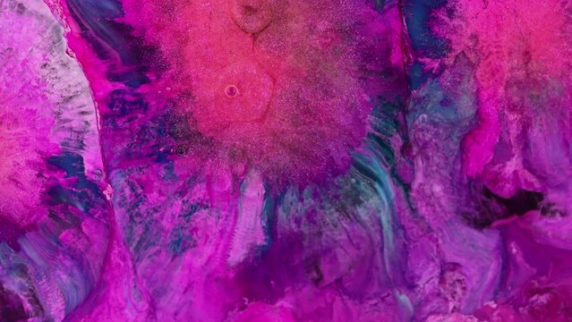 Abstract grunge background from an explosion of muted colors of ink paint. An overlay of sparkling liquid paint.