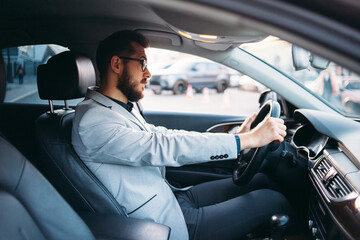 business executive driving car in city