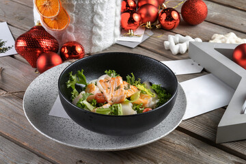 Salmon steak, squid, shrimp with salad to the New Year's table. Side view, macro
