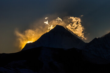 Mt. Dhaulagiri silhouette against sunset clouds, view from Muktinath. Annapurna circuit and Jomsom trek, Nepal.