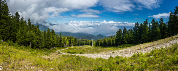 Ski slope on the Mt. Todorka in summer sunny day. Panoramic view of the Bansko and Razlog towns.