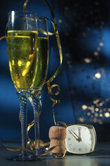 Happy New Year. Champagne glasses ready to bring in the New Year, golden bokeh background
