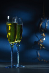 Happy New Year. Champagne glasses ready to bring in the New Year, golden bokeh background
