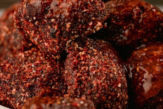 Closeup of natural tamarind with chili powder and chamoy on the white table, wall blurred background