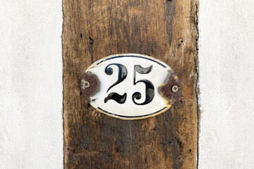 house number twenty-five 25 plaque on wall