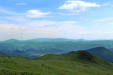 Beautiful shot of a green landscape under the white clouds