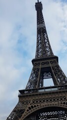 Fototapeta na wymiar Vertical low-angle view of the Eiffel tower landmark located in Paris, France