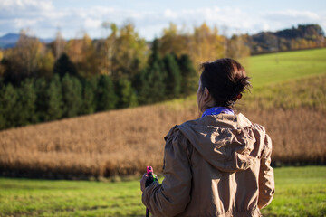 Lady in countryside watching the landscape and nordic walking