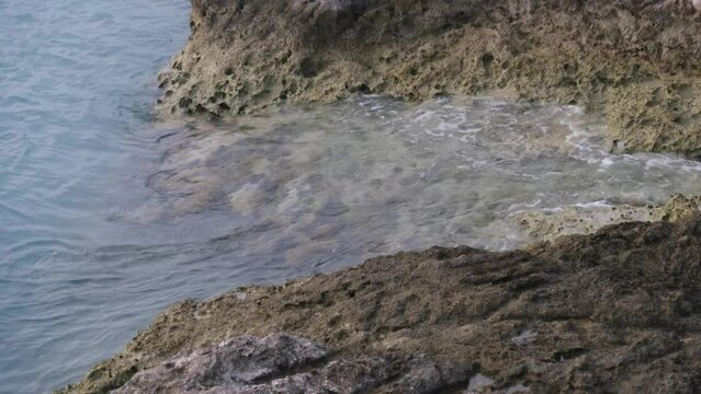 Ocean water rushing against the rocky shoreline