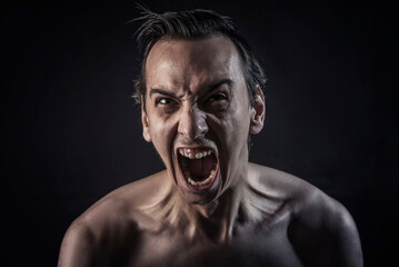 Dramatic screaming, young man completely mad with rage and fury