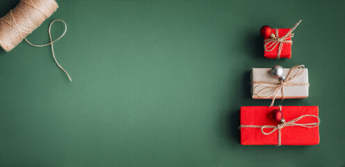 New Year banner with Christmas gift boxes and decorations on khaki background.