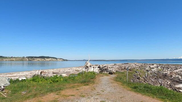 A bright sunny day n Whidbey Island showing the coastline with Mt Rainer in the distance while the camera pans to the right.
