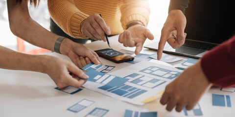 Young Asian business creative team work together, mobile application software design project. Brainstorm meeting, internet technology, smartphone web app designer, office coworker teamwork concept