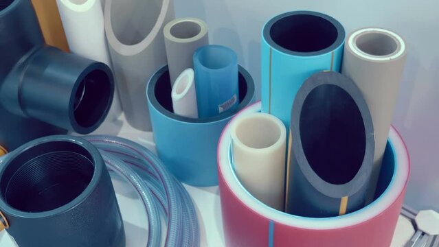 Samples of multilayer plastic pipes for cold and hot water supply, as well as for heating and sewerage at home. Closeup. Shot in motion