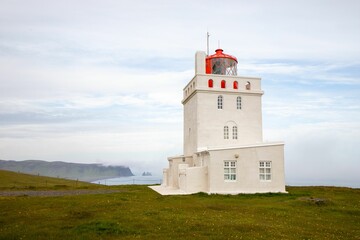 Fototapeta na wymiar Lighthouse of the Dyrholaey promontory on the coast of Iceland