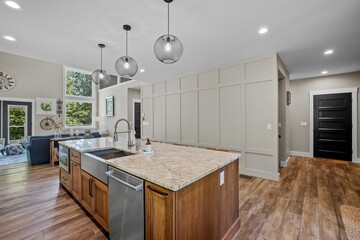 Interior design of a beautiful kitchen with a large island in a modern new England colonial home