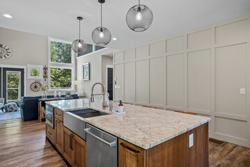 Interior design of a beautiful kitchen with a large island in a modern new England colonial home