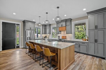 Interior design of a beautiful kitchen with a large island in a modern new England colonial home