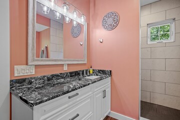 Beautiful interior design of a pink bathroom in a modern custom new England colonial home