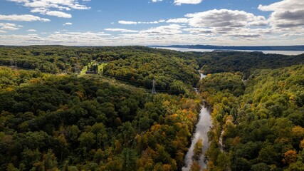 Drone shot of the Old Croton Trailway State Park on a sunny day in autumn with cloudy sky © Audley C Bullock/Wirestock Creators