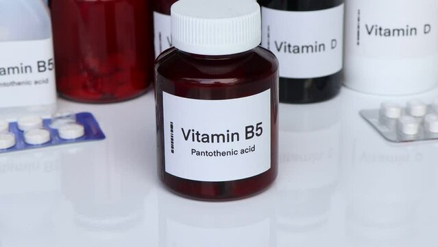Vitamin B5 pills in a bottle, food supplement for health or used to treat disease