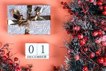 1 december calendar and christmas present on orange background with christmas tree decor - obrazy, fototapety, plakaty