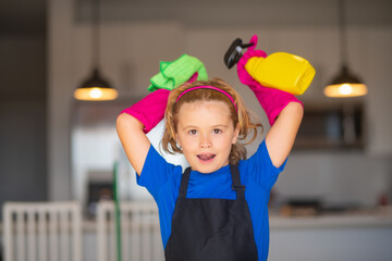 Little kid cleaning at home. Child doing housework having fun. Portrait of child housekeeper with wet flat mop on kitchen interior background.