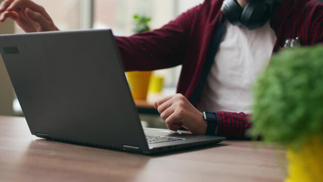 Tired office worker finishes work, takes a break, closes laptop. Overworked developer ends working day in coworking, goes home. Freelancer ends project, leaves workplace with computer for lunch.