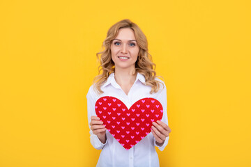 happy woman with red love heart on yellow background