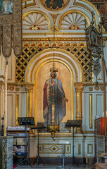 Fototapeta premium Helsinki, Finland - July 20, 2022: Uspenski Cathedral. Theotokos of Kozeltshan icon as important painting and prayer location. Golden framing, huge hanging candle holder and more