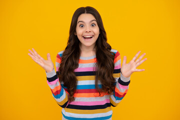 Amazed teenager. Excited teen girl. Portrait of joyful child girl with raised hands. Caucasian teenager screaming isolated on yellow. Happy child exclaiming with joy and excitement.