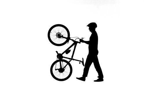 Side view on black silhouette of cyclist transporting a bicycle on back wheel. Male bicyclist in sportswear and a bicycle helmet on white background. Traveling, training, active rest.