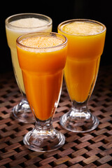 Assortment slush of Orange Mango Pineapple cocktail soda Drink served in glass isolated on table side view of middle east food
