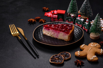 Homemade tasty cheesecake with jelly and raspberry berries on a black plate