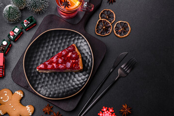 Homemade tasty cheesecake with jelly and raspberry berries on a black plate