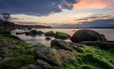 Beautiful colorful sunris at the sea with dramatic clouds and sun shining. Long Exposure of Soft and colorful sunset.