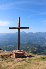 Fototapeta na wymiar Wooden cross on the top if the Italian mountain