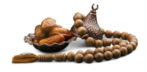 Date fruits in ornamental bowl with prayer beads.