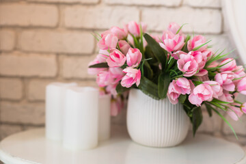 flowers in wicker basket on white wooden table, space for text. Spring blossom