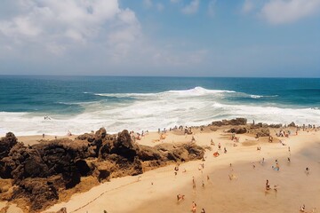 Fototapeta na wymiar People on the beach on Bali, Indonesia. Vacation and adventure. Beach and large waves. Top view from drone at beach, azure sea and relax people. Travel and relax image