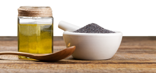 Black cumin oil with seeds on wooden desk