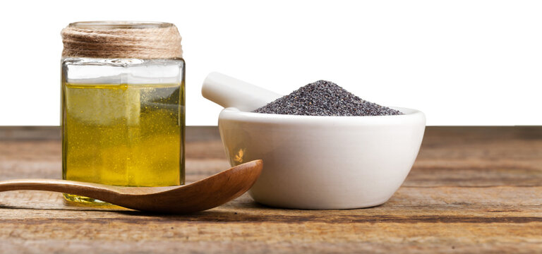 Black cumin oil with seeds on wooden desk