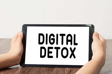 two hands holding a tablet with the word digital detx on it and an image of someone's hand - Powered by Adobe