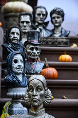 Scary sculptures and pumpkins outside the house as Halloween decorations.