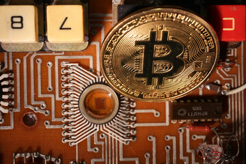 The bitcoin gold coin lies on an electronic circuit