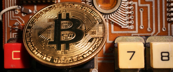 The bitcoin gold coin lies on an electronic circuit