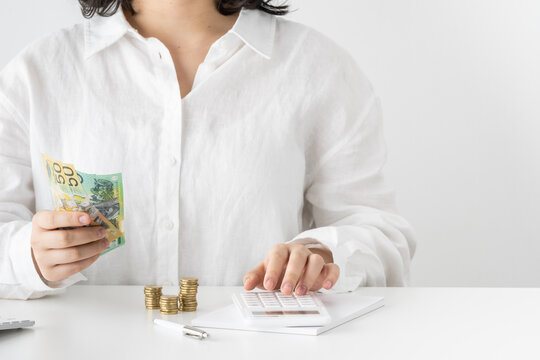 Women counting calculating Australian dollar currency money