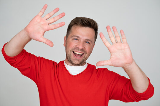 man showing number ten while smiling confident and happy. 