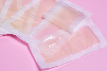 Fototapeta na wymiar three bags of skin care products on a pink background with text overlay that reads how to keep your skin clean
