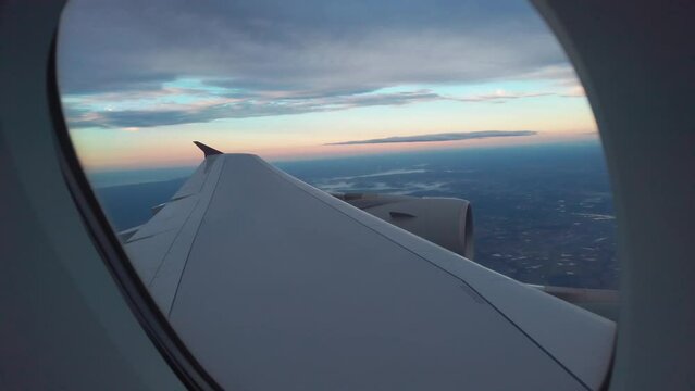 Passenger pov from flying plane window at sunset, sunrise